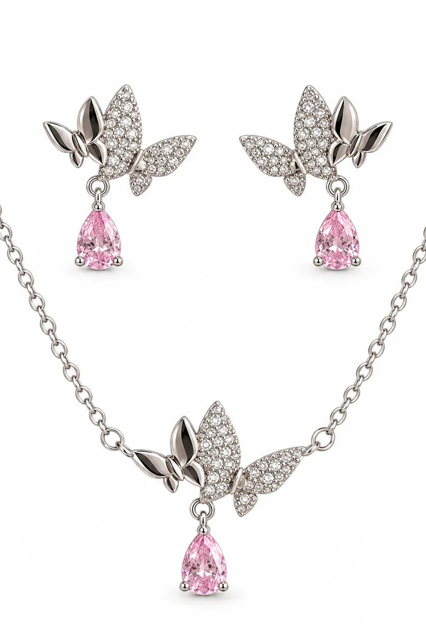 Silver-tone jewelry set featuring a necklace and matching earrings with butterfly-shaped crystal-encrusted tops and dangling pink teardrop gemstones, shown on a white background.