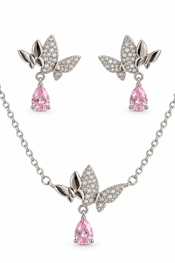 Silver-tone jewelry set featuring a necklace and matching earrings with butterfly-shaped crystal-encrusted tops and dangling pink teardrop gemstones, shown on a white background.